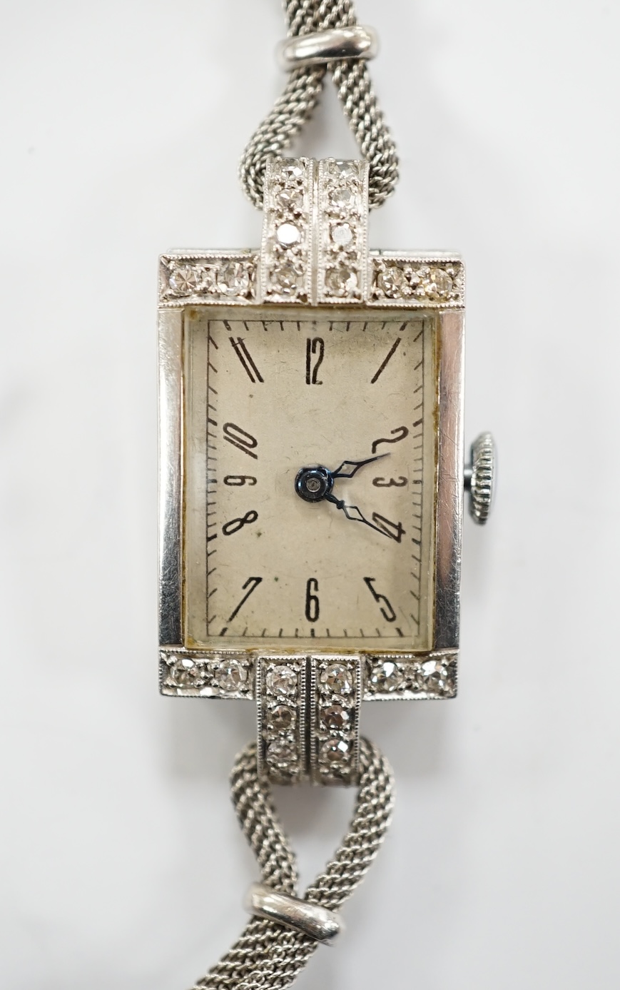 A lady's white metal and diamond set rectangular dial manual wind cocktail watch, on a 9ct white gold, bracelet, gross weight 17.4 grams.
